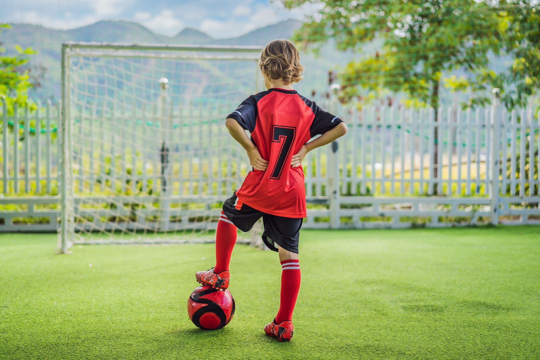  Boy in Red Football Uniform Playing Soccer